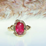 Gold ring with ruby and two hearts